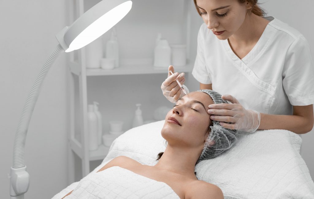 beautician doing filler injection female client 0